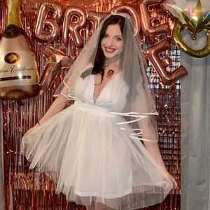 White tulle mini dress with lace detail.